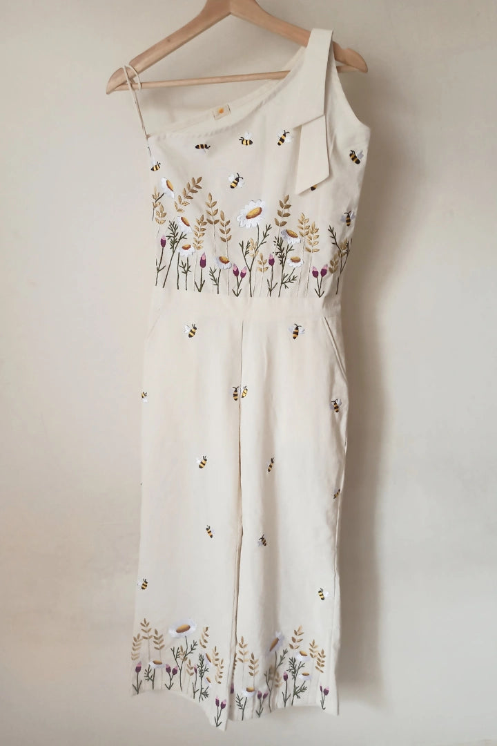 Ilamra sustainable clothing organic cotton Off-white hand block printed jumpsuit which comes with slightly flared pants with side hip slant pockets, side zip closure and hand-embroidered lush flower beds and honey bees. Cool and convenient to wear