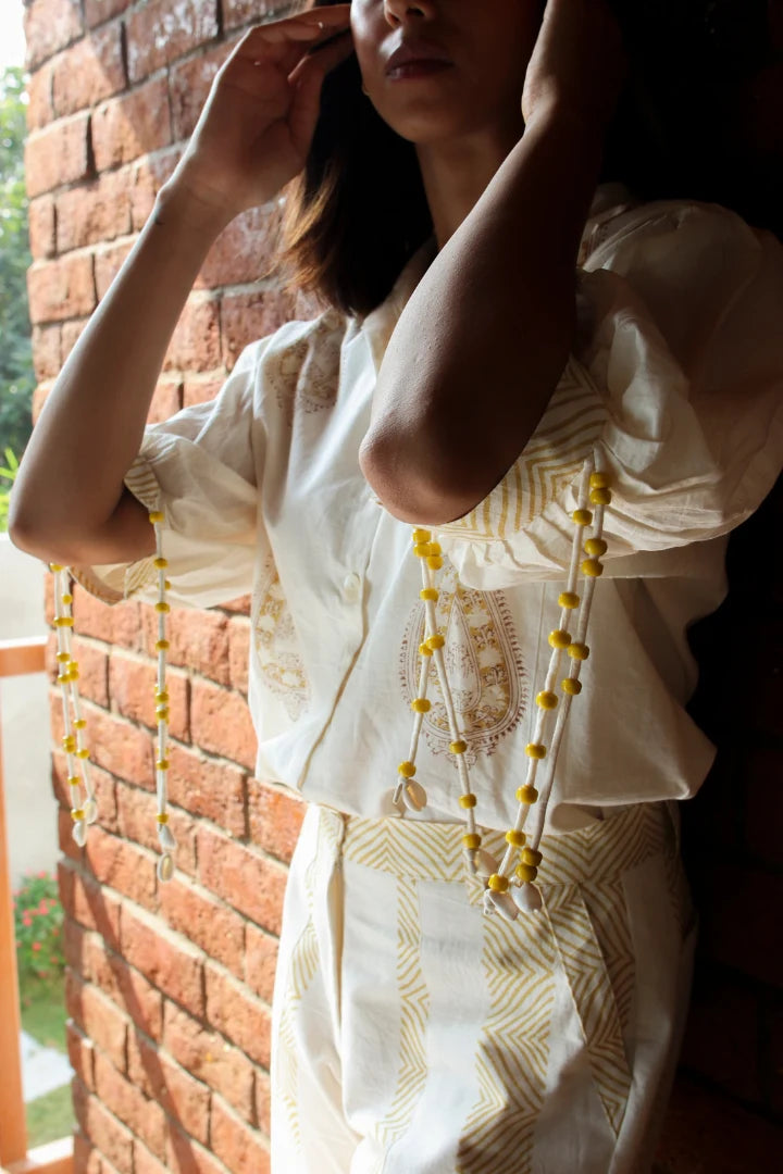 ilamra hand block printed naturally dyed organic cotton white pants with yellow print
