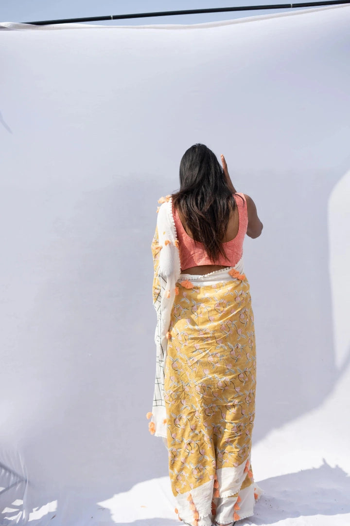 Ilamra kalamkari craft hand block printed organic cotton Mustard yellow with black, red and peach detailing over a pebble white base saree