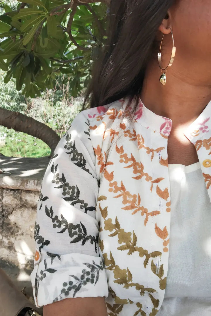 Ilamra hand block printed sustainably made naturally dyed Pebble white base with orange, pink, lime green and dirty green motifs peppercorn print jacket