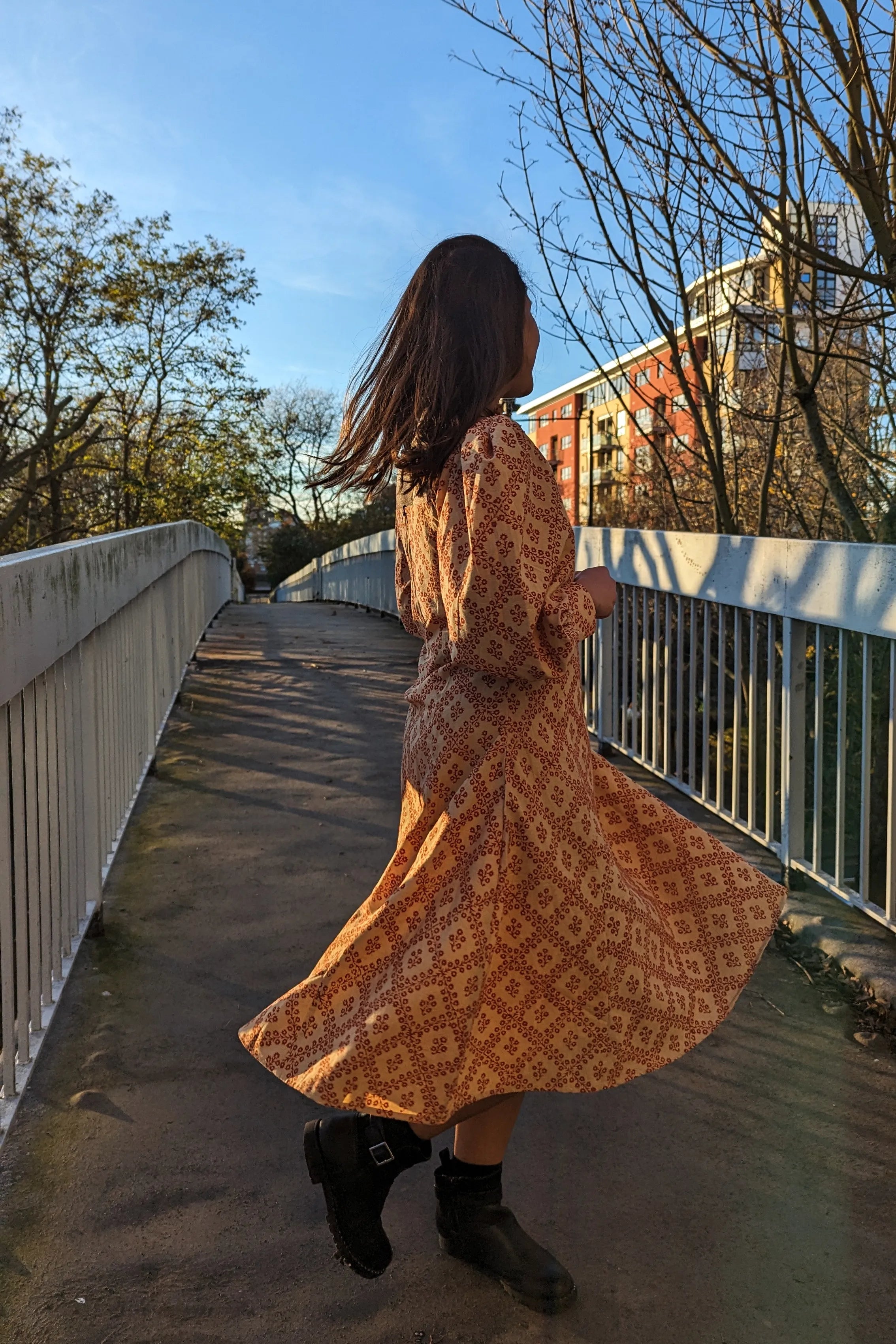 Ilamra hand block printed Kalamkari art organic cotton naturally dyed in Madder red against a beige background, big sleeves, elegant, classy, chic dress