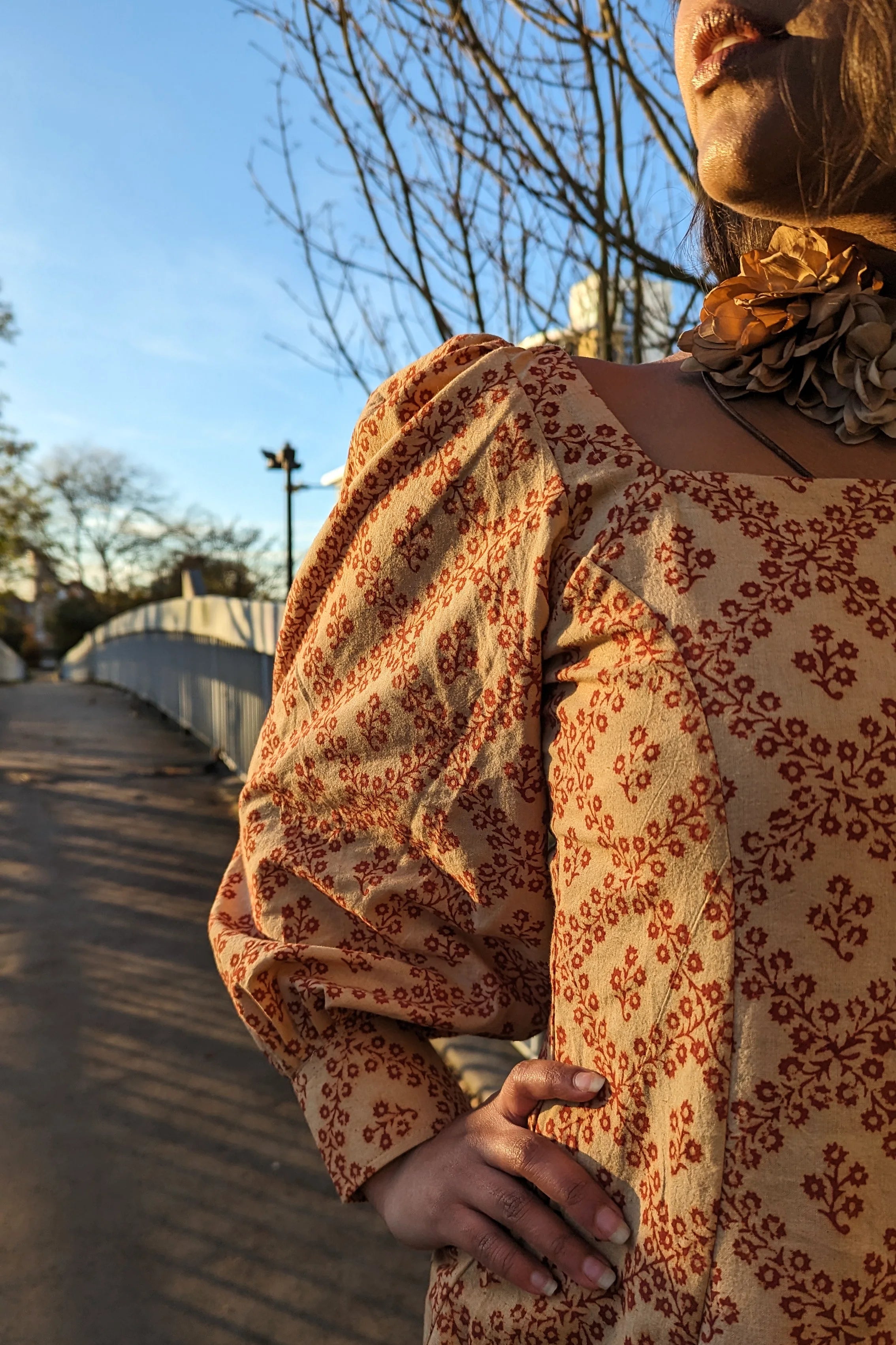 Ilamra hand block printed Kalamkari art organic cotton naturally dyed in Madder red against a beige background, big sleeves, elegant, classy, chic dress