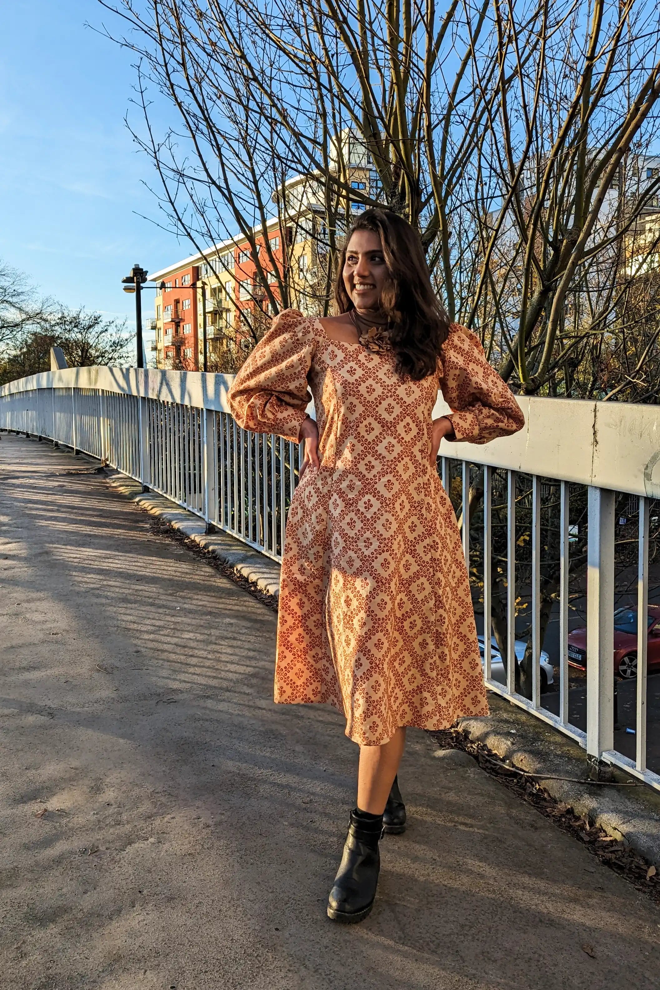 Ilamra hand block printed Kalamkari art organic cotton naturally dyed in Madder red against a beige background, big sleeves, elegant, classy, chic dress