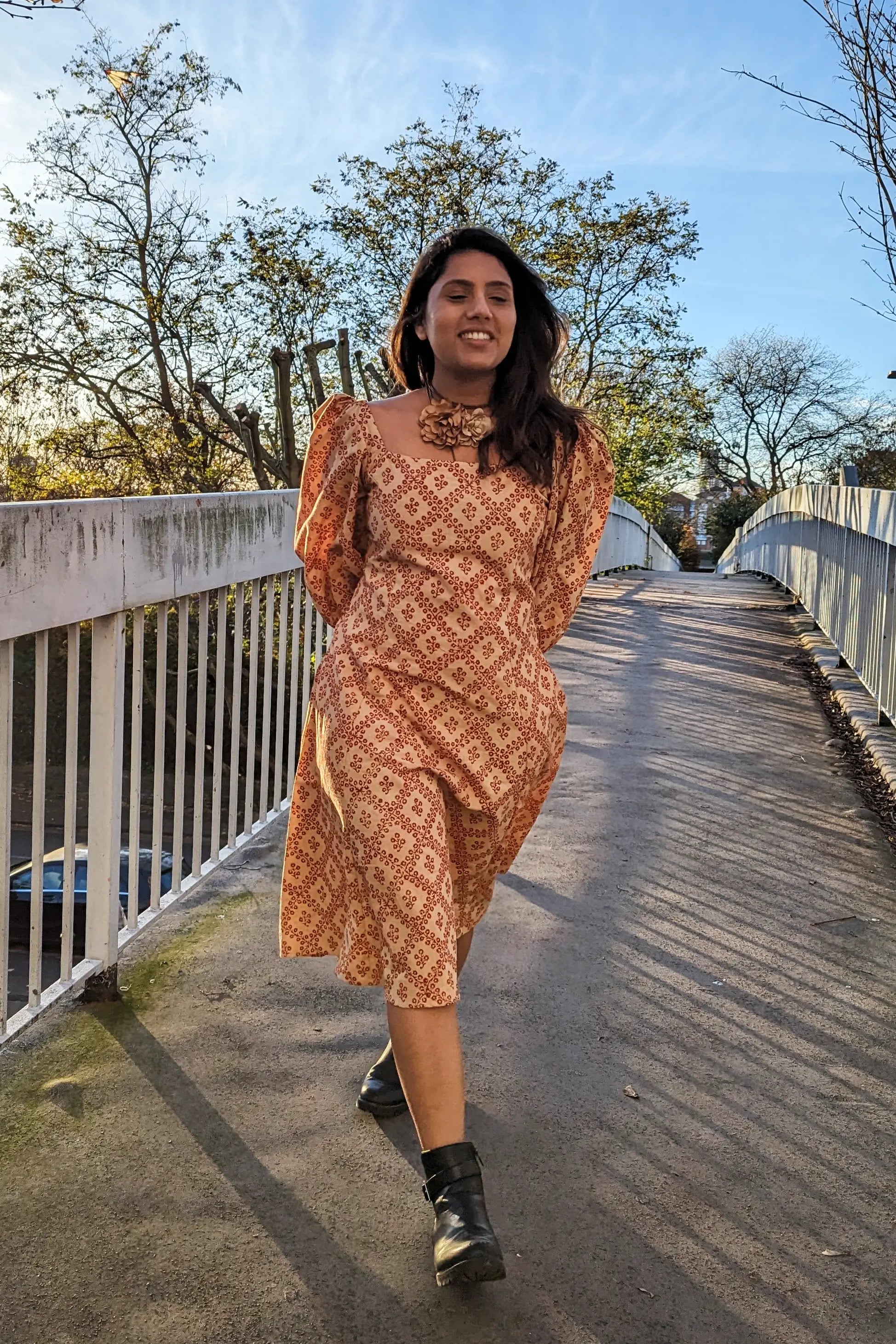 Ilamra hand block printed Kalamkari art organic cotton naturally dyed in Madder red against a beige background, big sleeves, elegant, classy, chic dress
