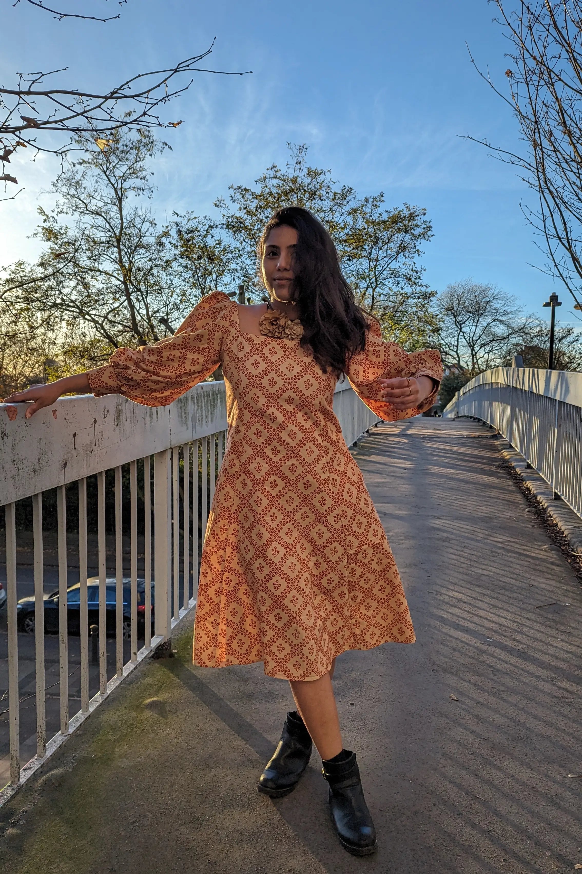 Ilamra hand block printed Kalamkari art organic cotton naturally dyed in Madder red against a beige background, big sleeves, elegant, classy, chic dress