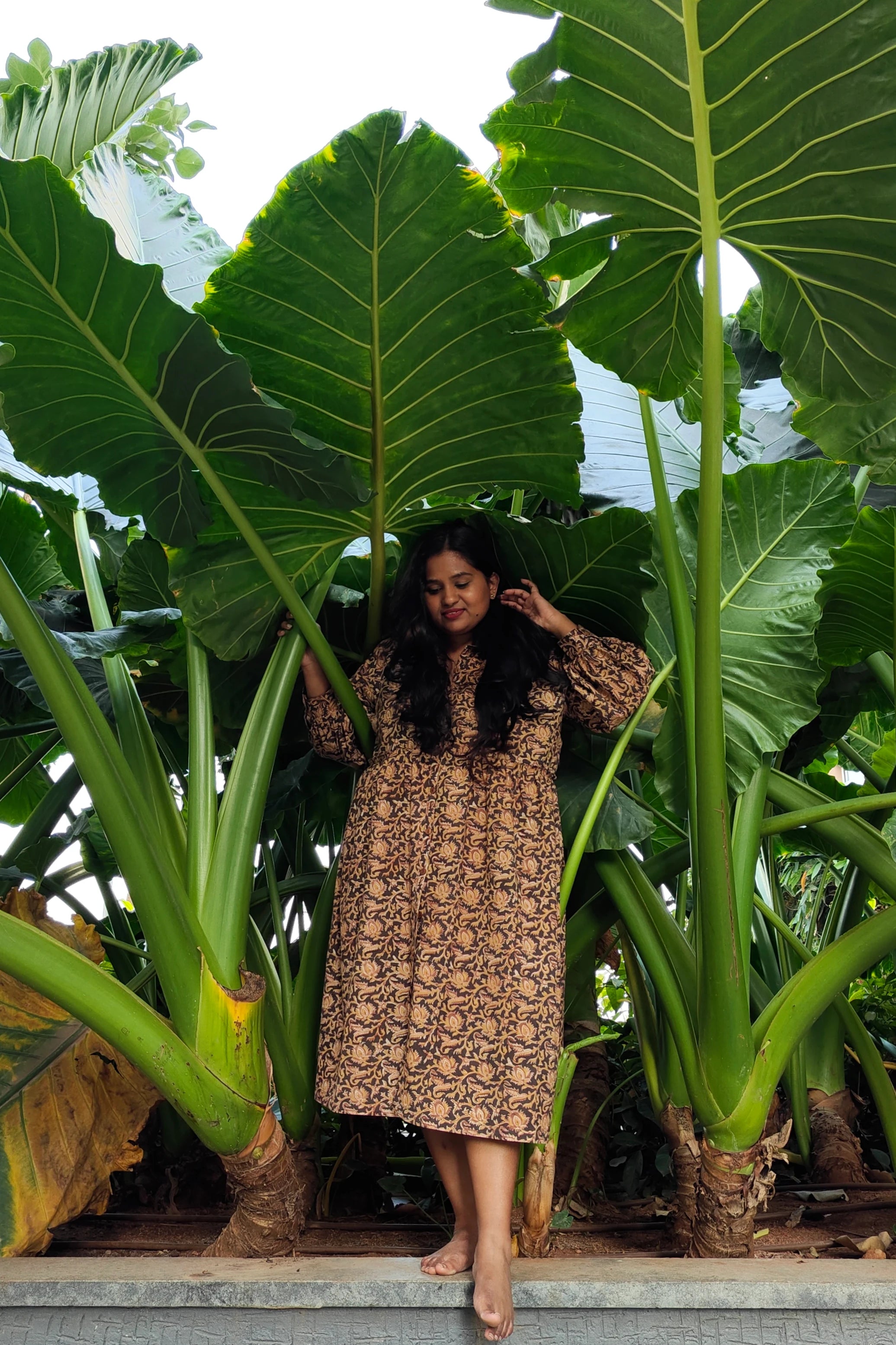 Ilamra hand block printed Kalamkari art organic cotton naturally dyed black, hazel, and beige, ruffle detailing, balloon sleeves ending in cuffs, calf-length dress