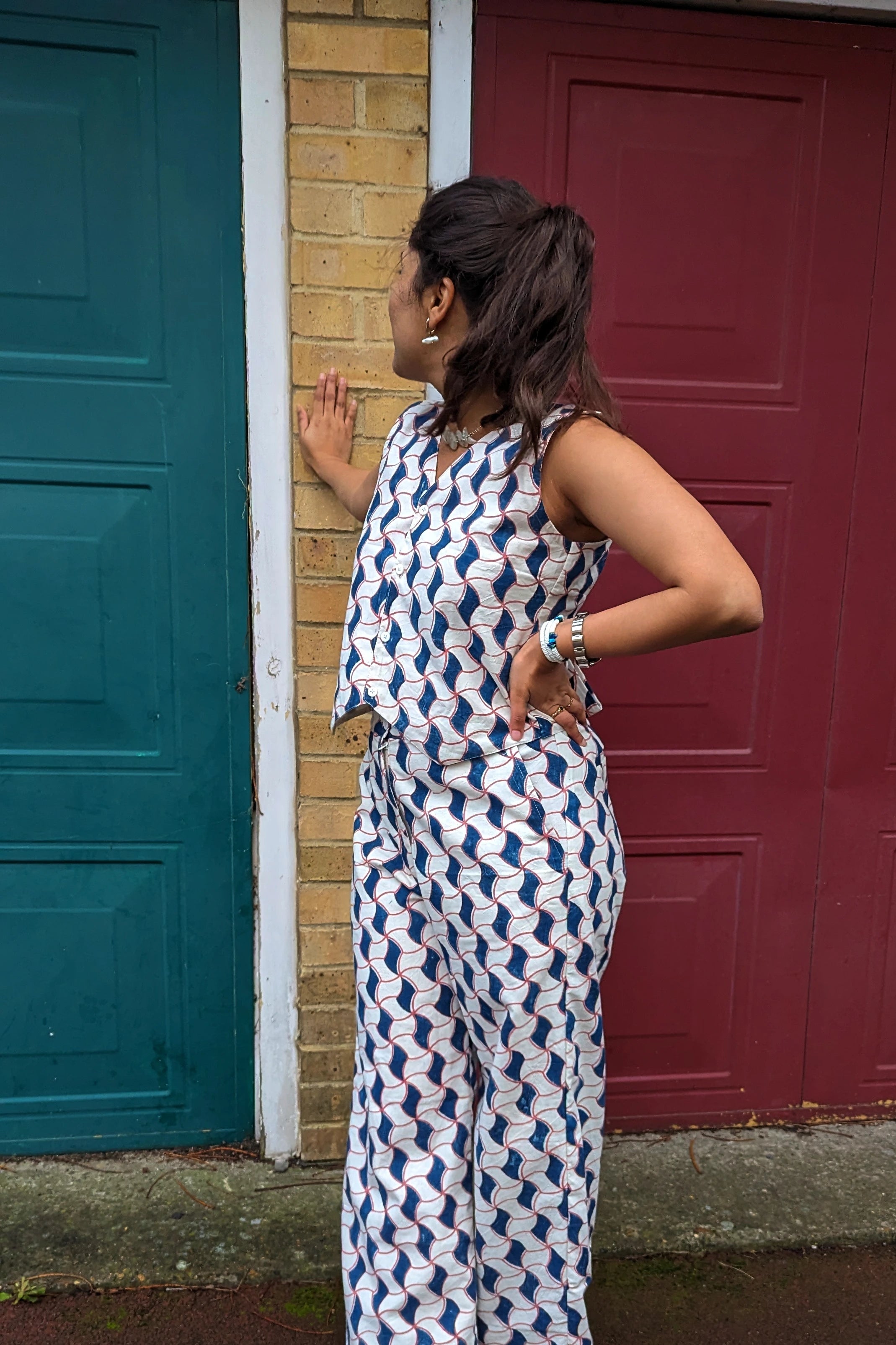 Ilamra hand block printed Kalamkari art organic cotton naturally dyed sharp v-neck and button-down fastening, fitted vest and relaxed pants.