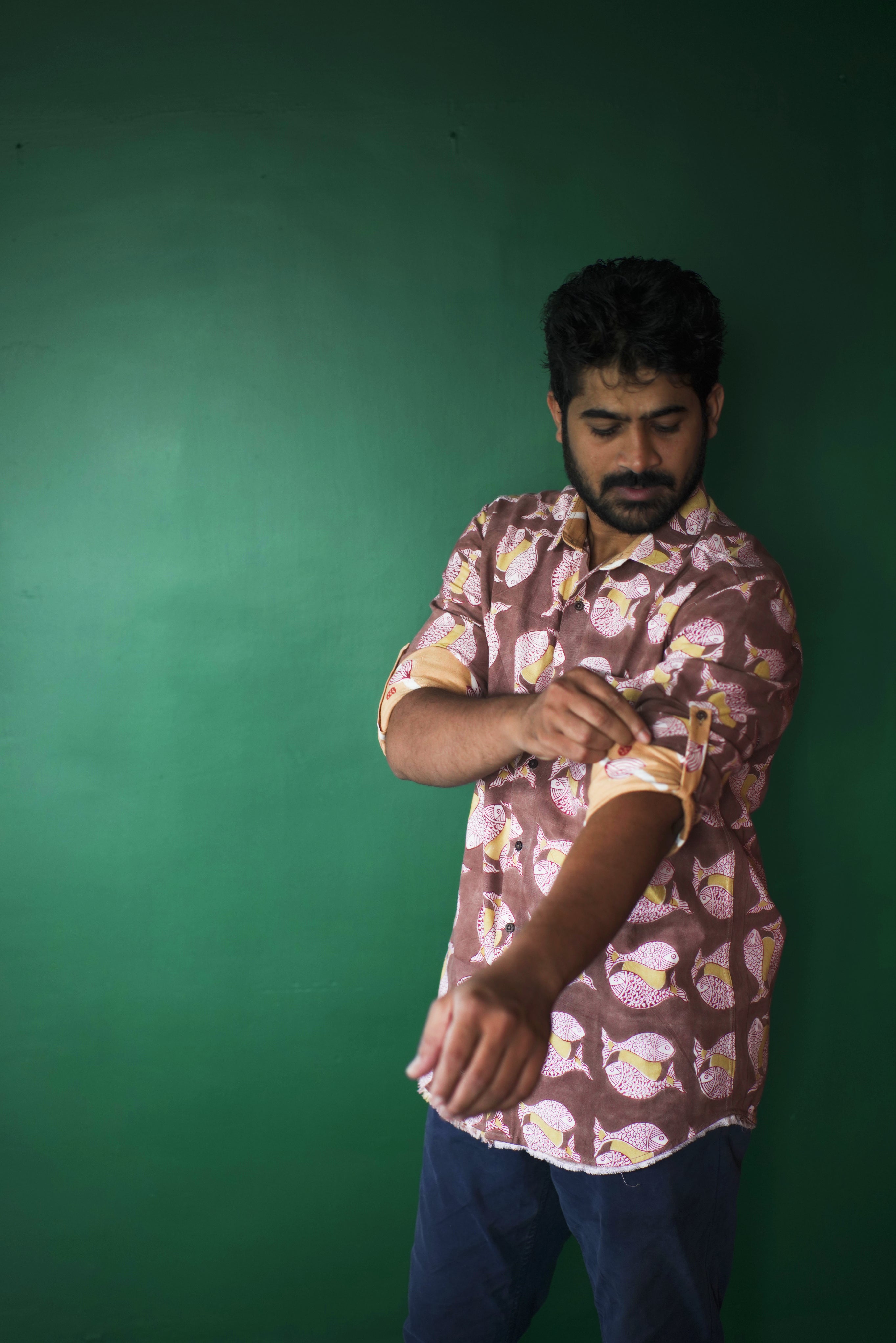 Men's full sleeve cotton shirt featuring fish and sun motif hand block printed using natural dyes in the shades of brown, yellow and red.