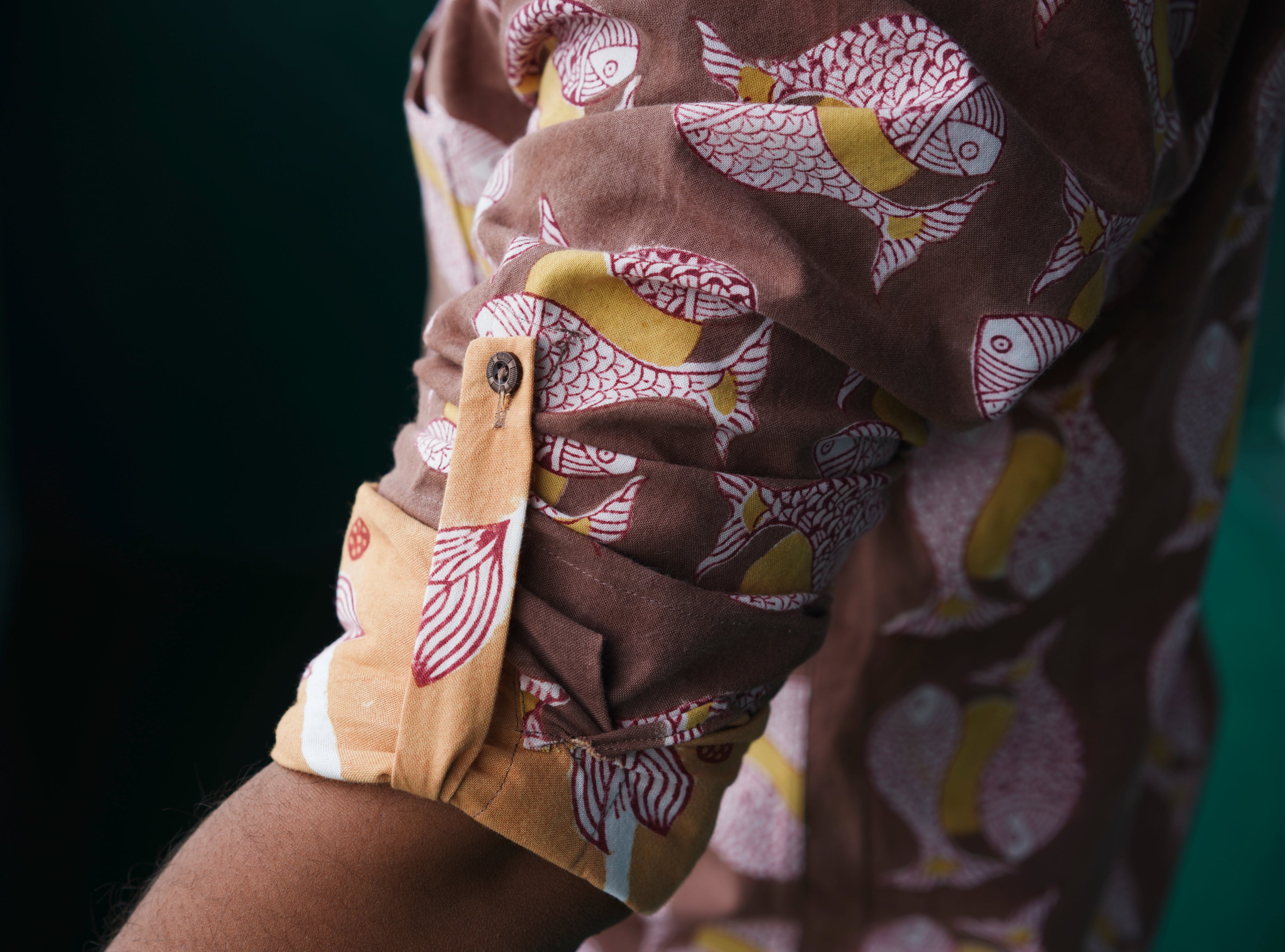 Men's full sleeve cotton shirt featuring fish and sun motif hand block printed using natural dyes in the shades of brown, yellow and red.