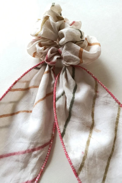 ilamra hand block printed naturally dyed organic cotton Off-white, hints of orange, blush pink, light green and dirty green upcycled cotton fun scrunchie