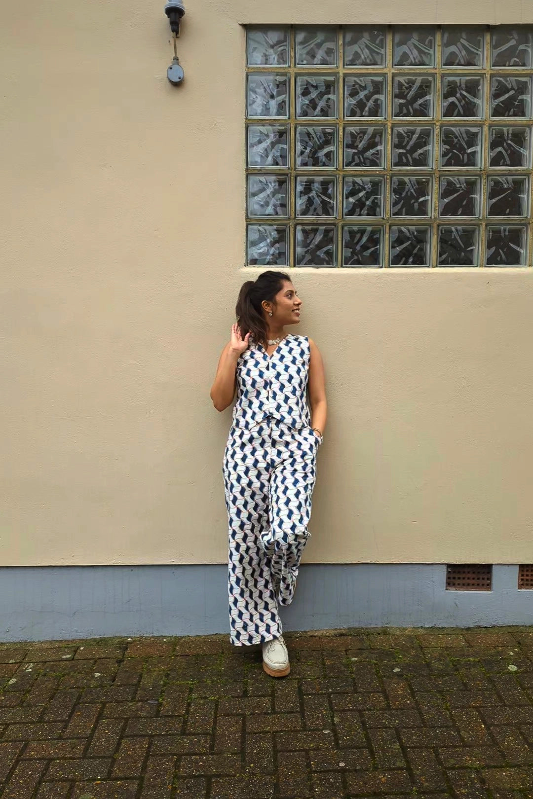 Ilamra hand block printed Kalamkari art organic cotton naturally dyed sharp v-neck and button-down fastening, fitted vest and relaxed pants.